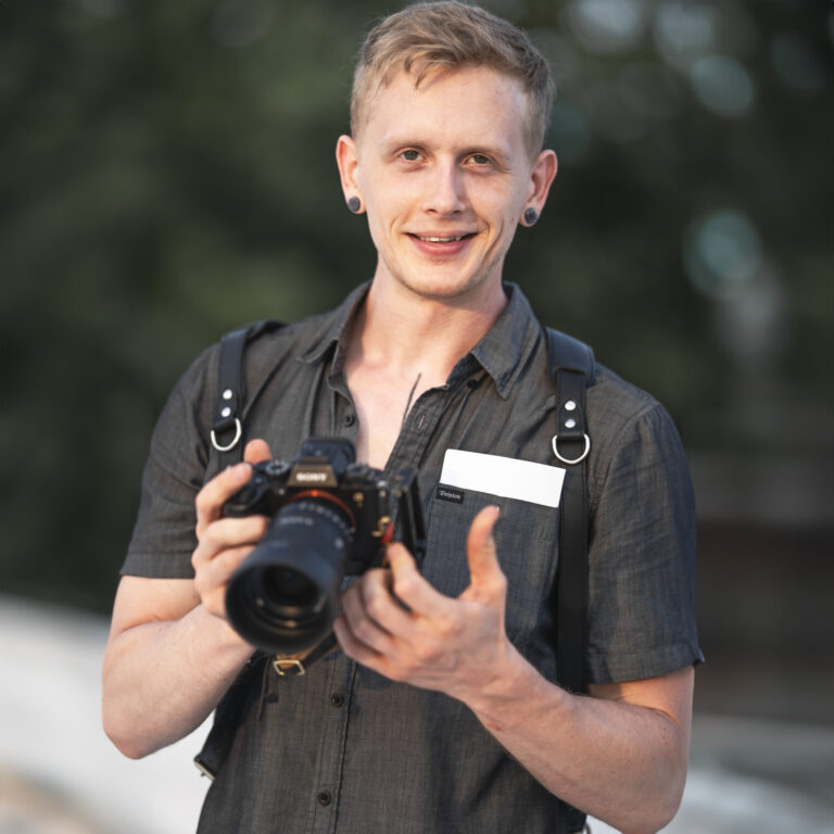 Portrait of Pennsylvania photographer holding camera during an engagement session in Lancaster, Pennsylvania